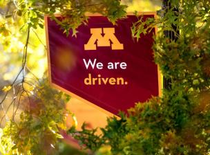 UMN Campus Mall Banner: "We Are Driven"
