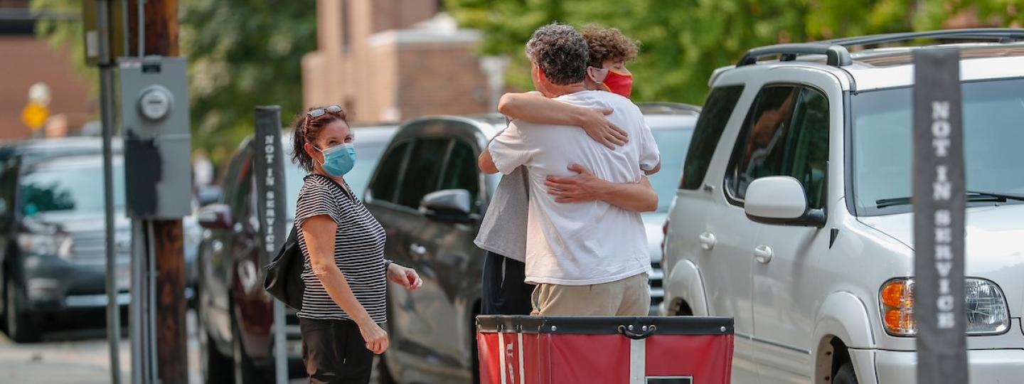 Parents hug their son on move-in day 2020