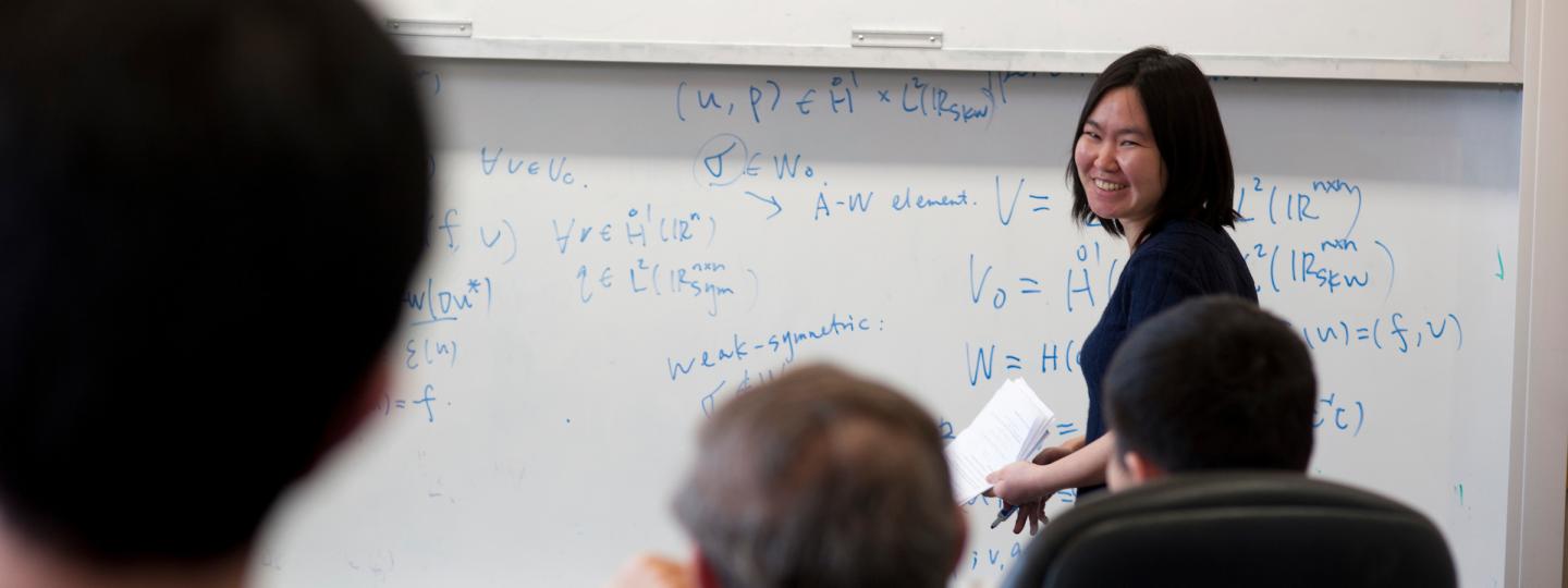 Math professor at the whiteboard in front of a class