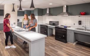 Students use a community kitchen space in Pioneer