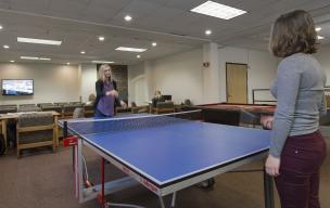 Students playing ping pong in the gaming area of the main lounge.