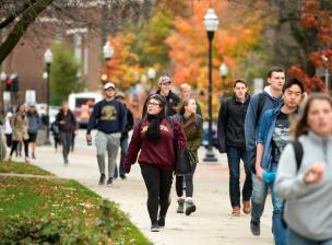 Students walking to class on a fall day.