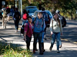 Students walking and talking outside on campus