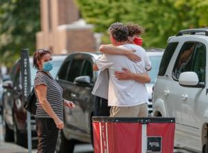 Parents hug their son on move-in day 2020