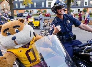 goldy in the side car of a police motorcycle 