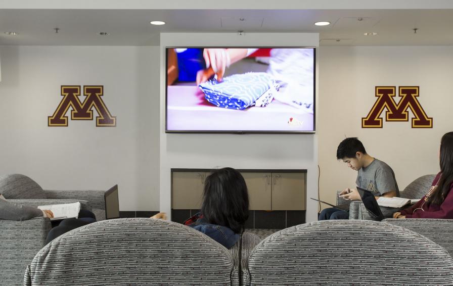 Students watching TV in the club room.